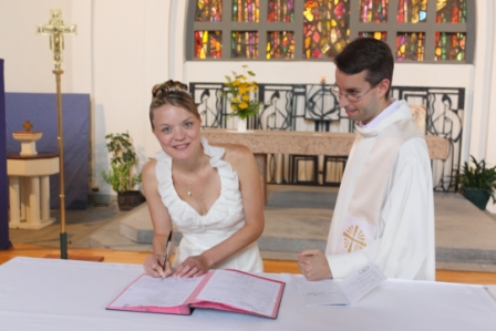 Amélie Guillouët signing the marriage register at the church in La Chabossière, France