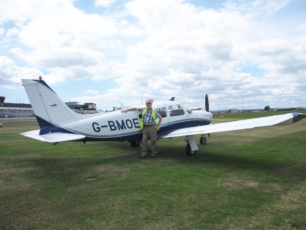 Peter Barker at Exeter Airport with Piper Cherokee Arrow II G-BMOE prior to flight to Cherbourg, France