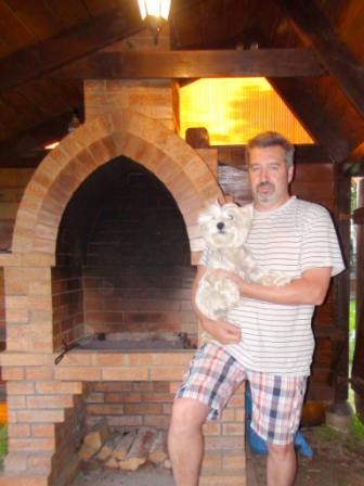 Sergei Dymnikov with Mitya, in front of his barbeque.  (Mitya is a West Highland Terrier)